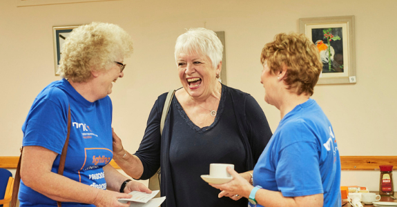 Volunteers laughing together.