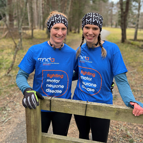 picture of two people wearing mnda branded t-shirts