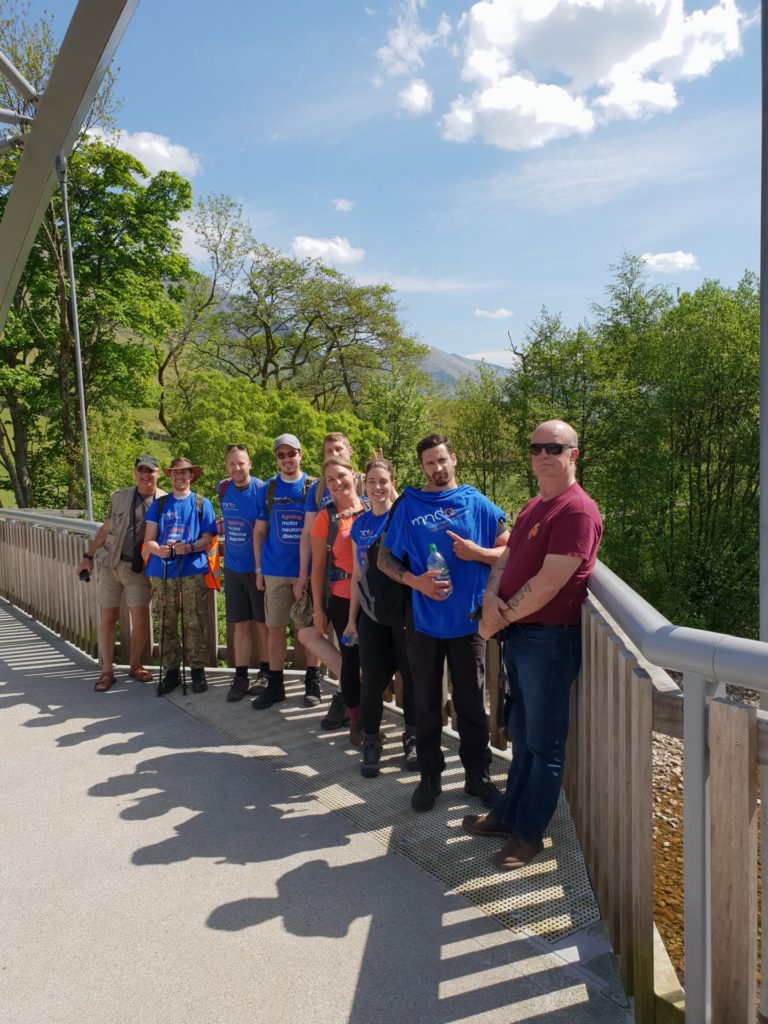a group of people wearing mnd association t-shirts