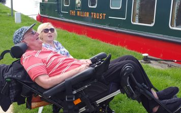two people sitting aside a canal