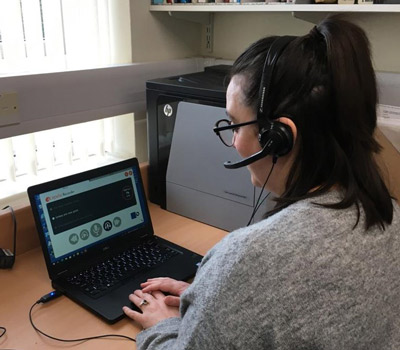 photo of a person with a voice banking device 