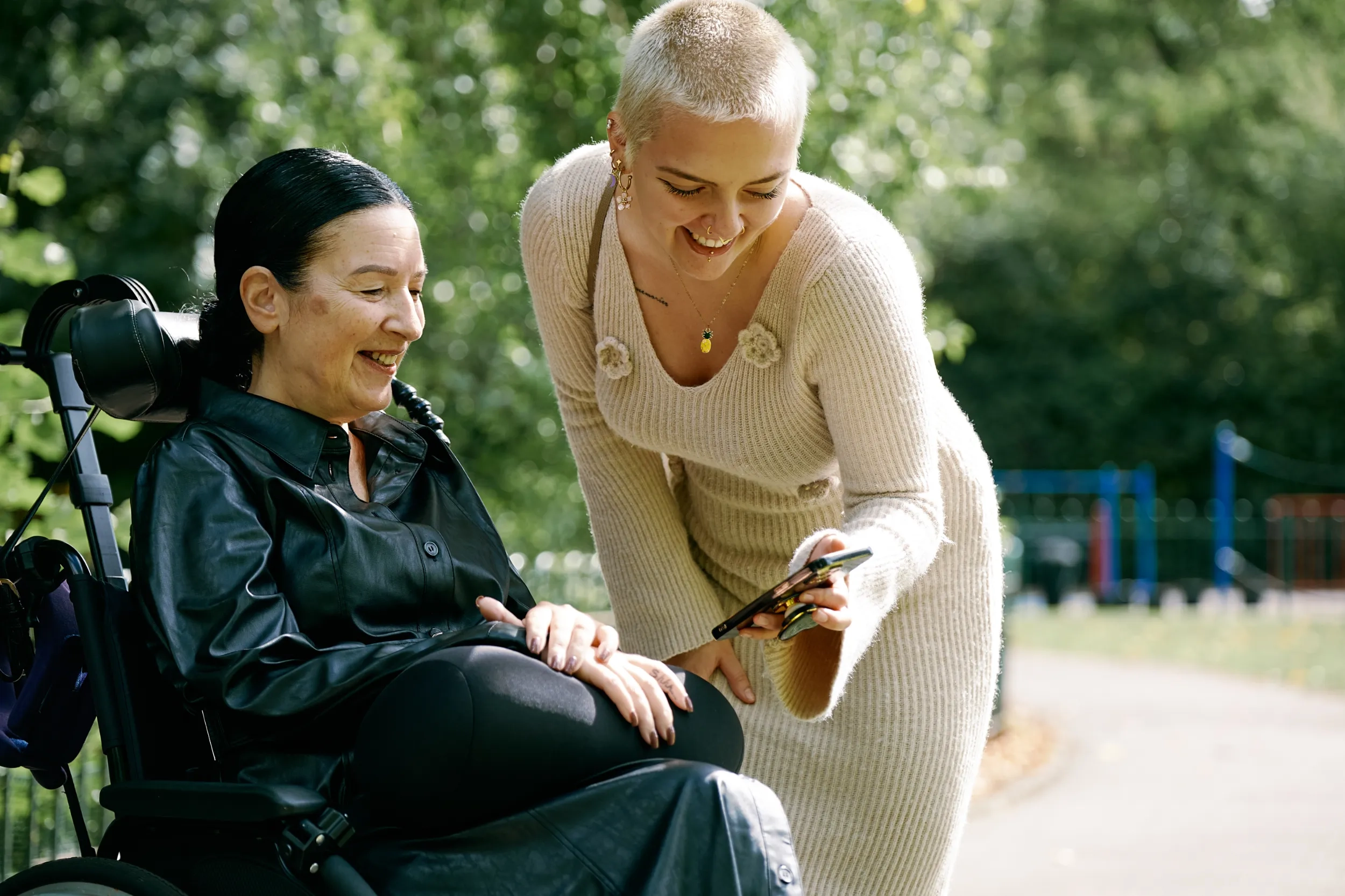 Two women look at a phone