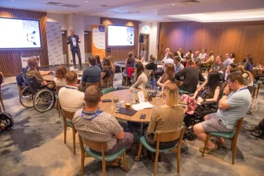A full room of people listening to a talk at MND EnCouRage 2025.