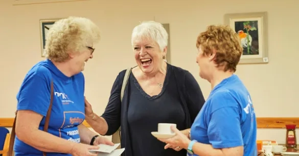 Volunteers laughing together.